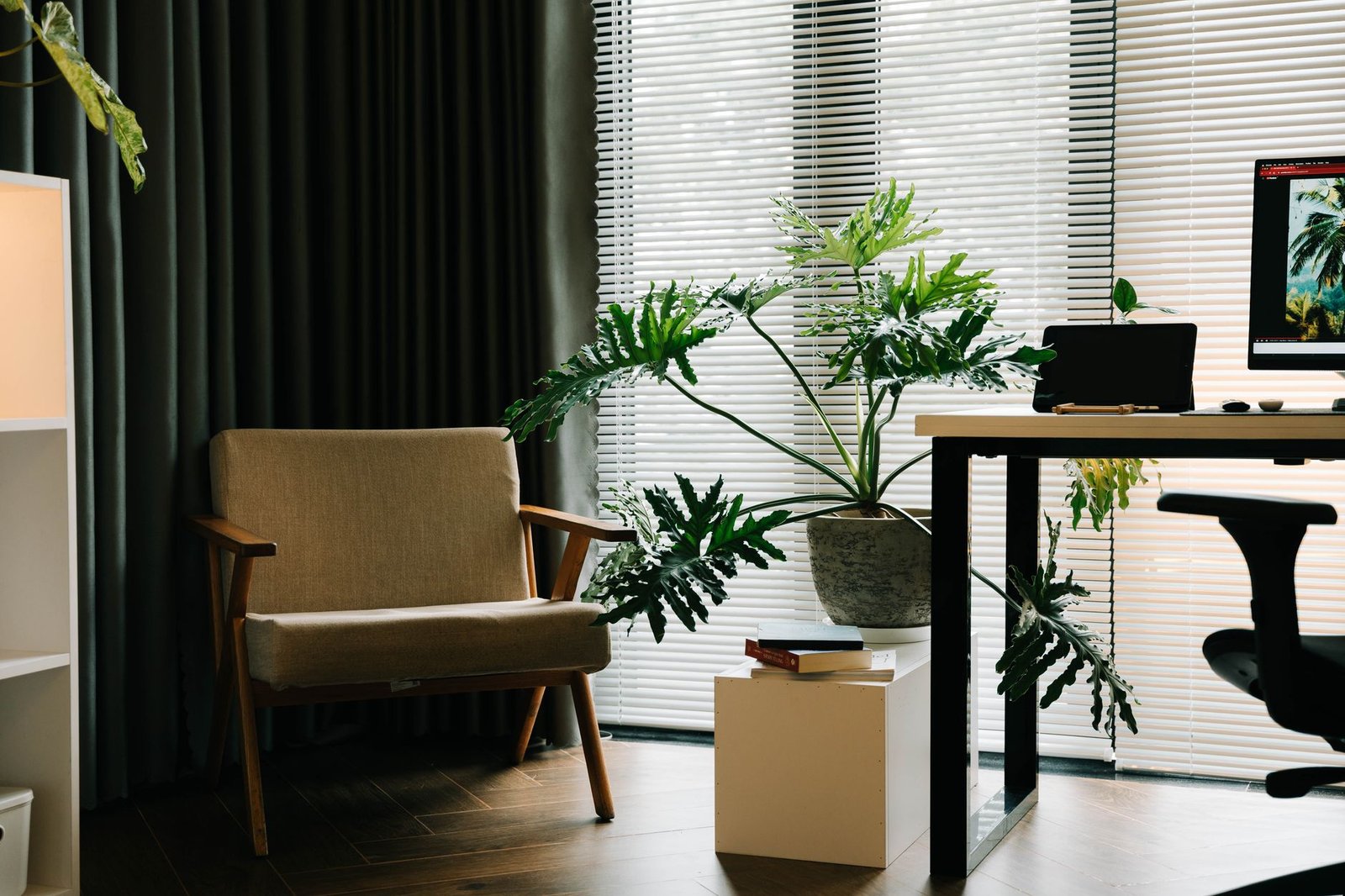 A quiet room with an armchair and plants